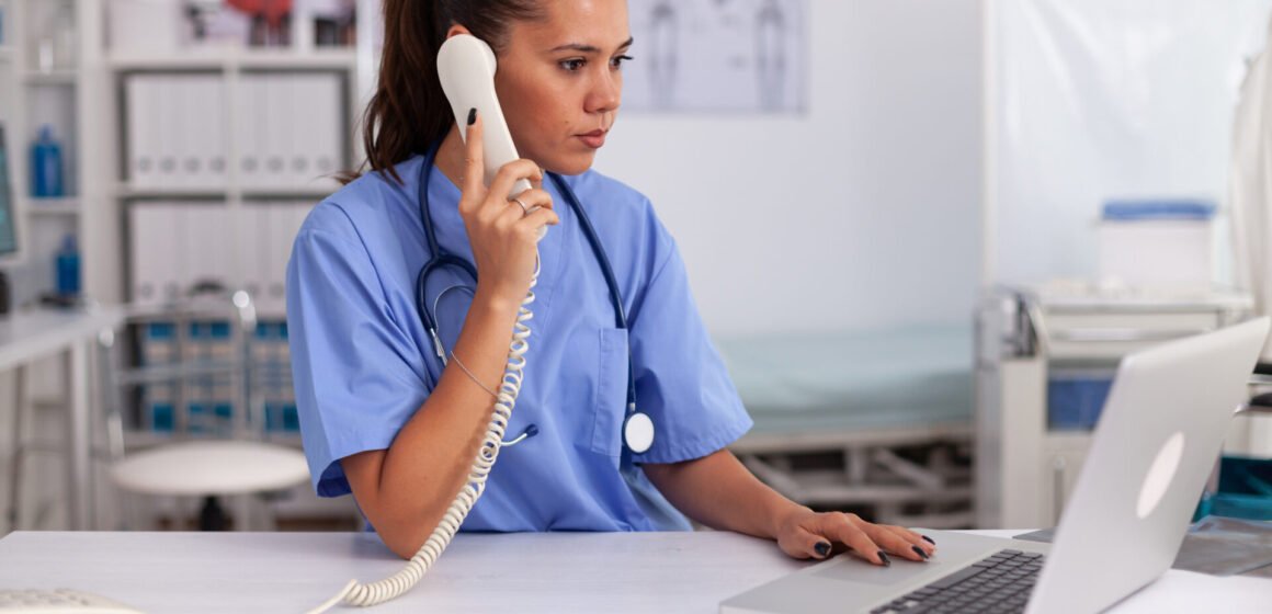 Medical practitioner answering phone calls Why Phoenix Clinics Are Turning to Healthcare Virtual Assistants