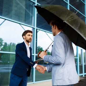 Picture of two young businessmen meeting at station background 5 Ways Captive Insurance Gives Businesses Greater Risk Control